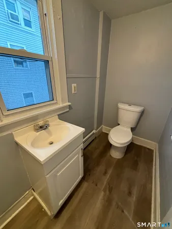a bathroom with a sink toilet and a mirror