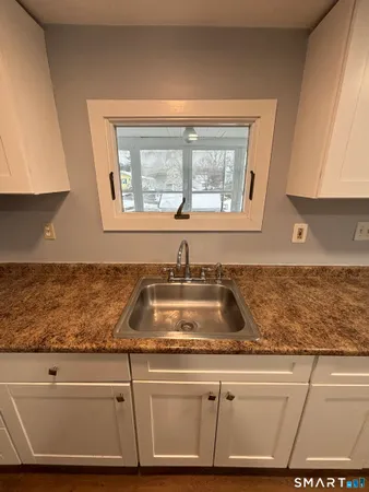 a kitchen with granite countertop a sink and a window