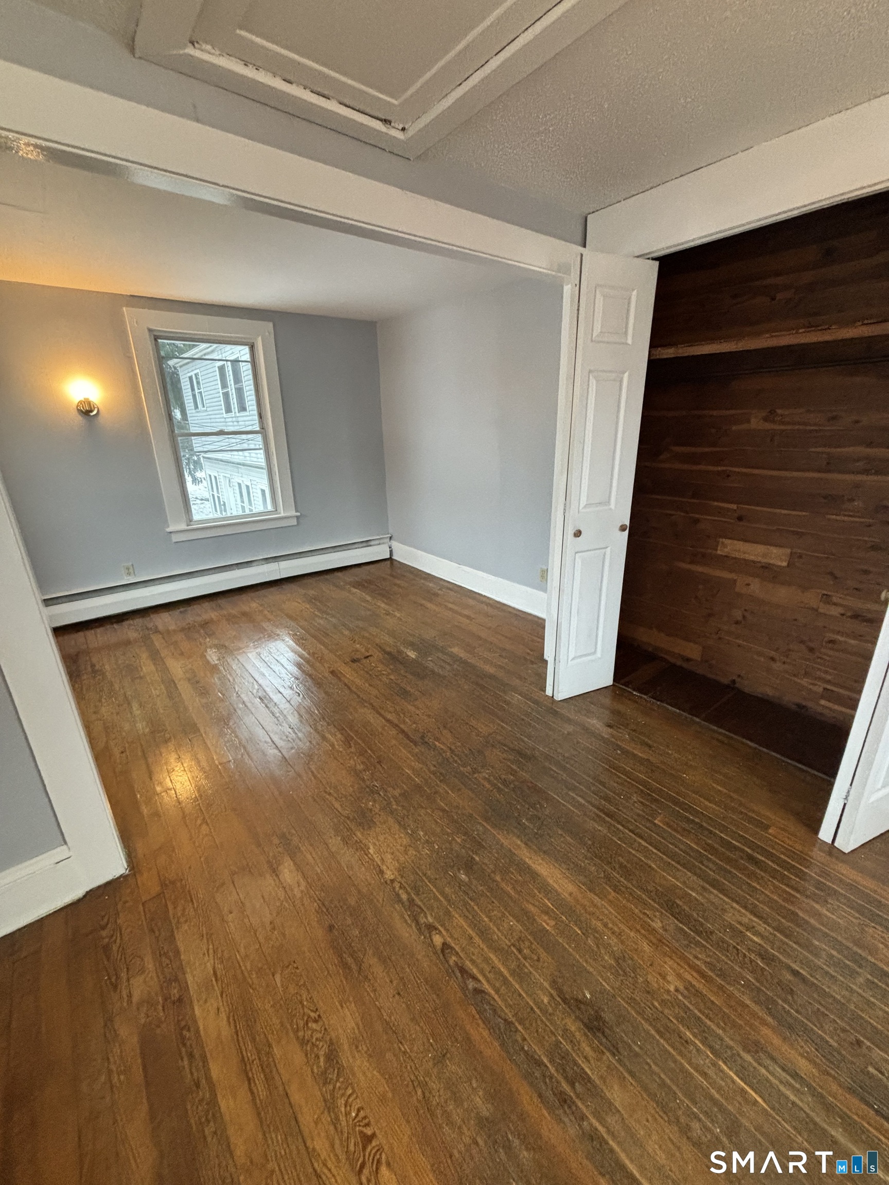 126 Main Street Terryville, CT 06786 - Photo 9 of 14 a view of an empty room with wooden floor and stairs