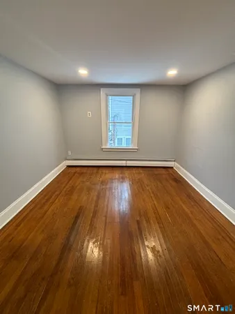 a view of room with wooden floor and window