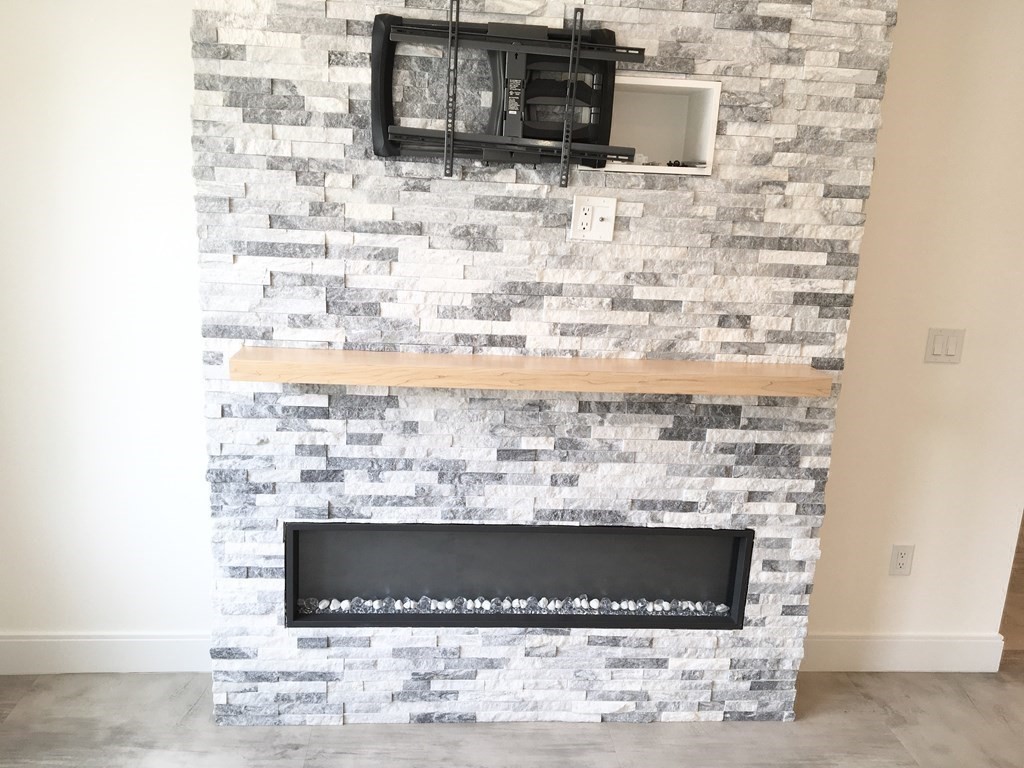 2239 Washington Street, Unit 200 Canton, MA 02021 - Photo 11 of 35 a view of fireplace and microwave