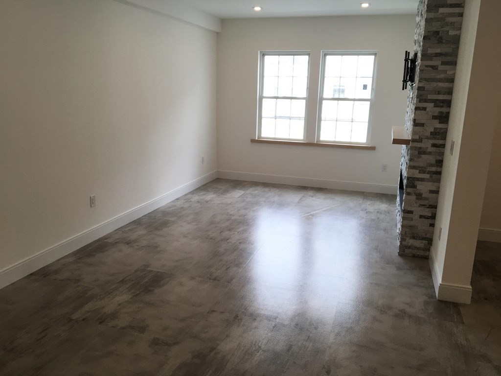2239 Washington Street, Unit 200 Canton, MA 02021 - Photo 12 of 35 an empty room with wooden floor and windows