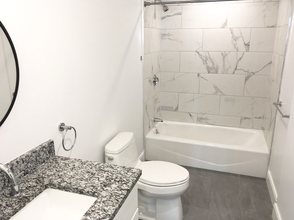 2239 Washington Street, Unit 200 Canton, MA 02021 - Photo 23 of 35 a bathroom with a toilet and a bathtub
