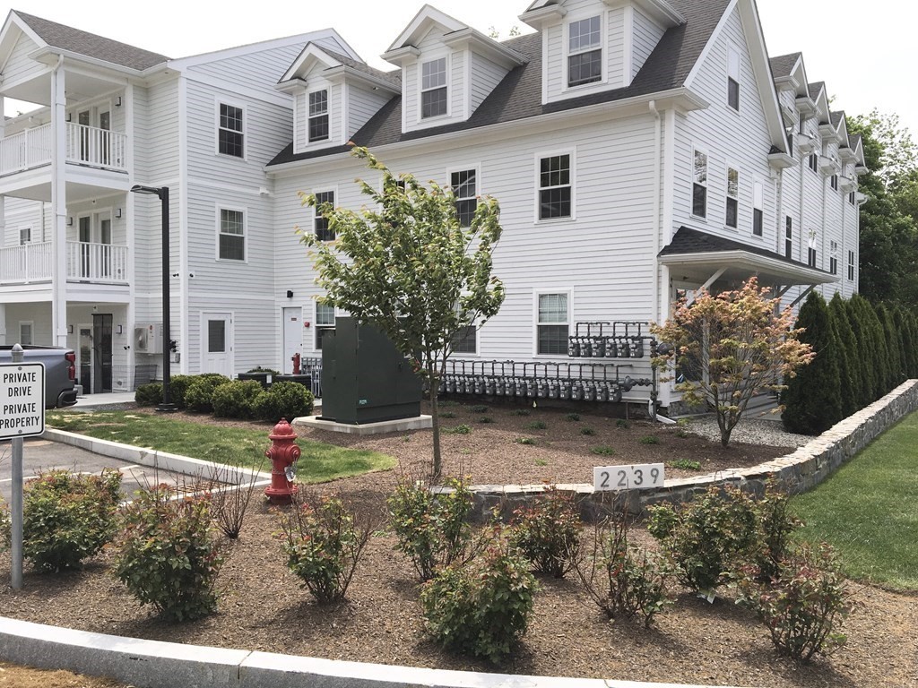 2239 Washington Street, Unit 200 Canton, MA 02021 - Photo 3 of 35 a view of a white house next to a yard