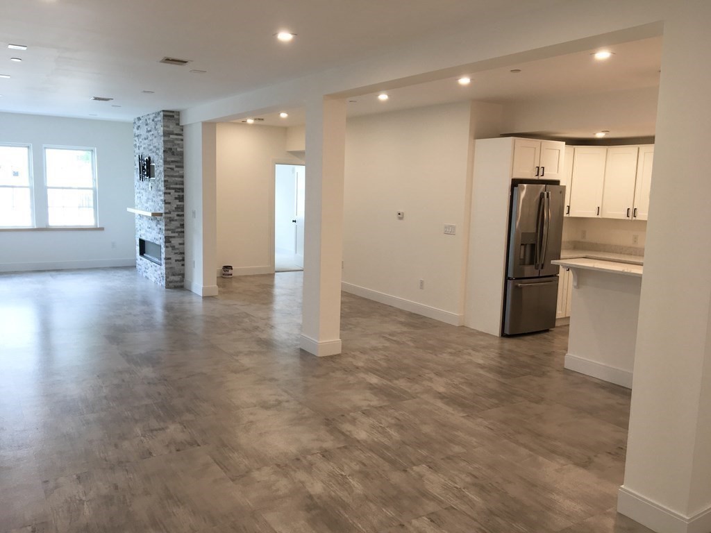 2239 Washington Street, Unit 200 Canton, MA 02021 - Photo 31 of 35 an empty room with wooden floor and windows