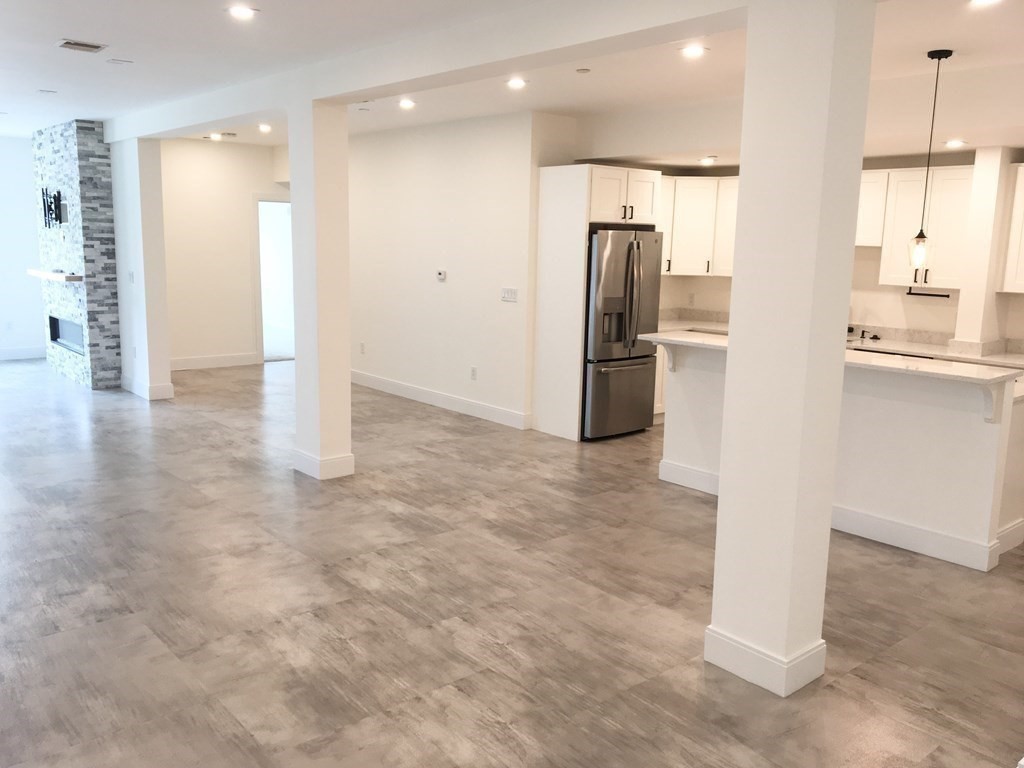 2239 Washington Street, Unit 200 Canton, MA 02021 - Photo 8 of 35 a view of a kitchen with a refrigerator and a sink