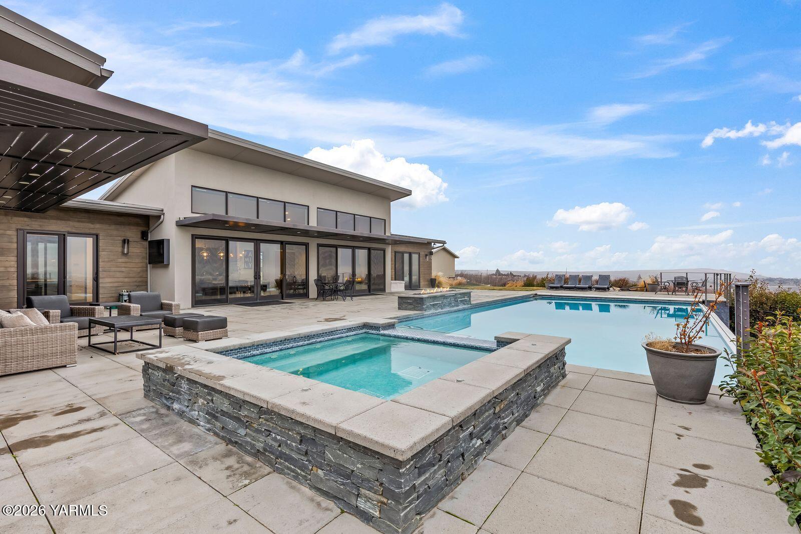 13990 Marble Road Yakima, WA 98908 - Photo 55 of 60 a view of a patio with couches and table and chairs and potted plants