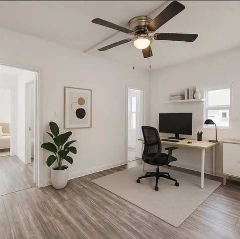 a living room with furniture and a potted plant