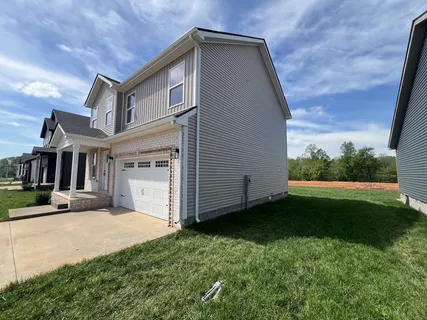 an empty room with wooden floor and a ceiling fan