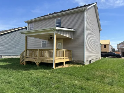 a large kitchen with a large counter top stainless steel appliances and cabinets