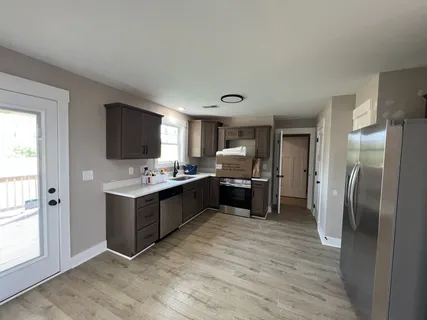 a bathroom with a toilet a sink a mirror and a bathtub