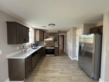 an empty room with windows and ceiling fan