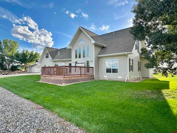 a view of a house with a yard and sitting area