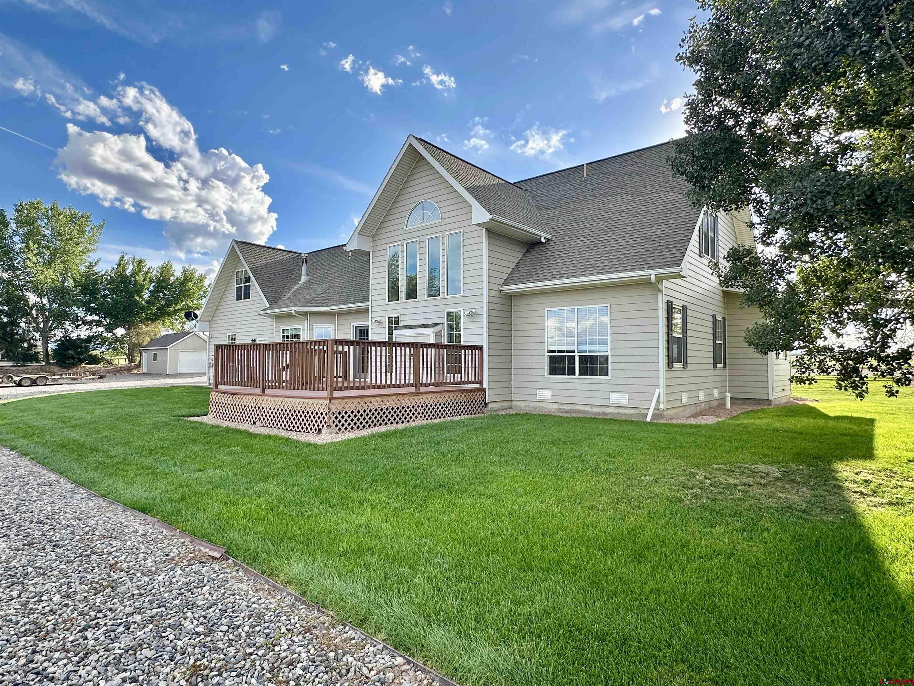 a view of a house with a yard and sitting area