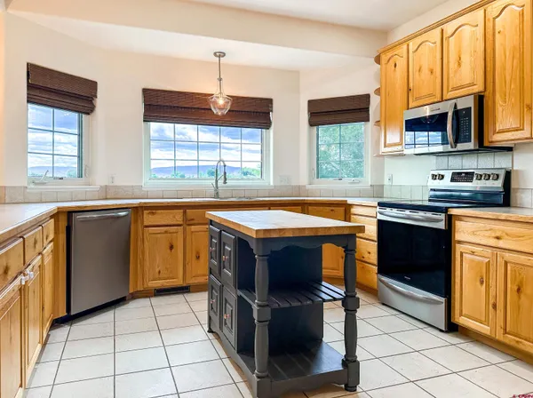 a kitchen with stainless steel appliances granite countertop a stove a sink dishwasher a microwave oven with granite countertops and cabinets