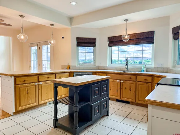 a kitchen with a stove a sink a dining table and chairs