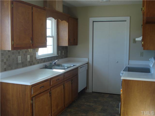 804 Tilghman Road Coats, NC 27521 - Photo 3 of 6 a kitchen with a sink stove and cabinets