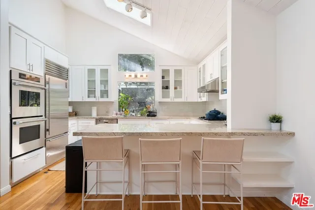 a kitchen with a sink and refrigerator