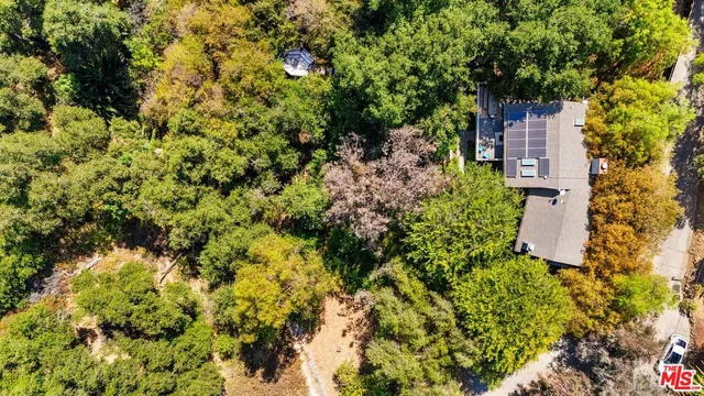 a view of a house with large trees