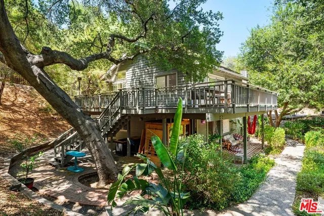 a view of a patio with table and chairs and potted plants