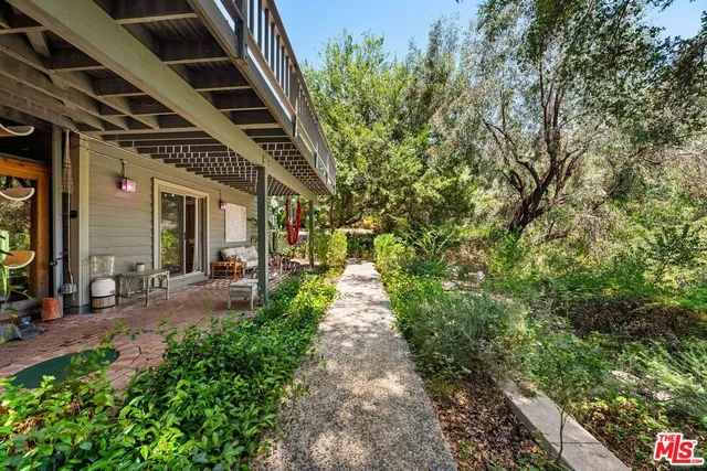 a view of a balcony with wooden floor and outdoor seating