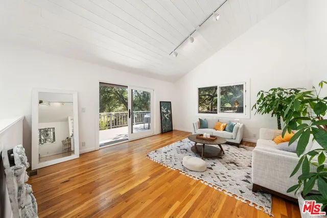 a living room with furniture windows and wooden floor