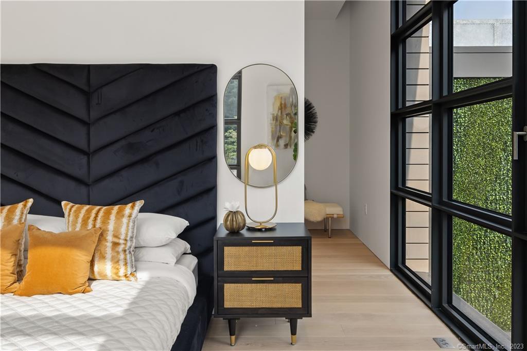 a view of a bedroom with wooden floor and a bed