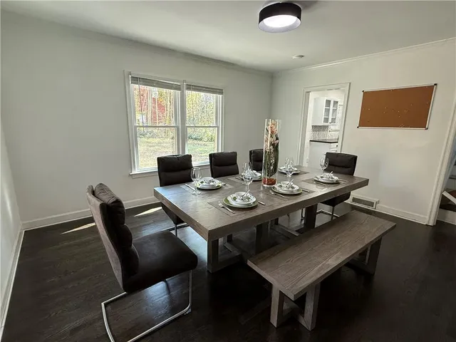 a view of a dining room with furniture and wooden floor