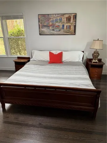 a bedroom with a bed and window