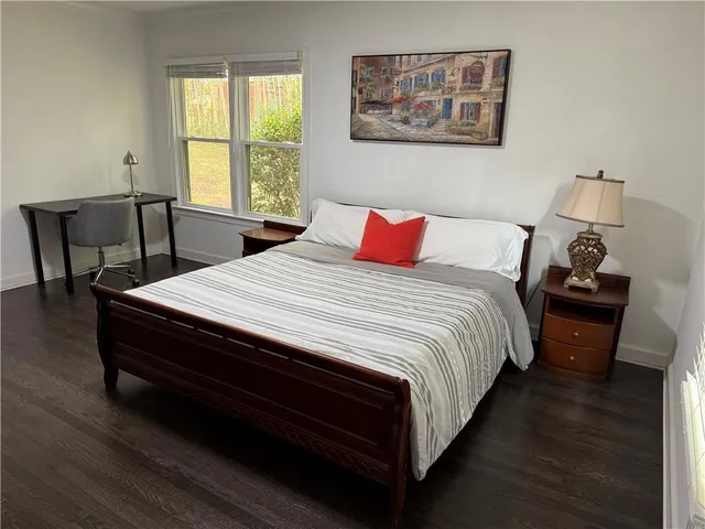 a bed sitting in a bedroom next to a window