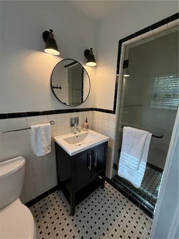 a bathroom with a sink toilet and mirror