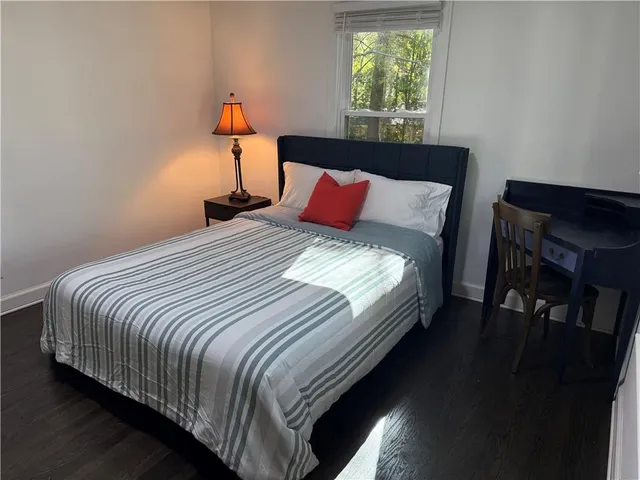 a bed sitting in a bedroom next to a window