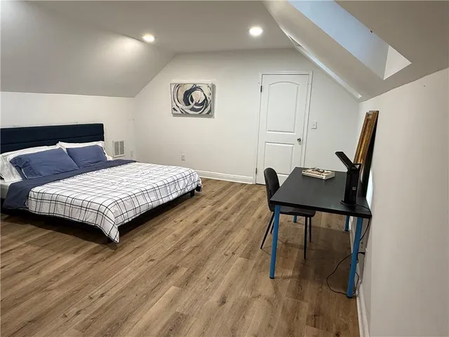 a bedroom with a bed and a table