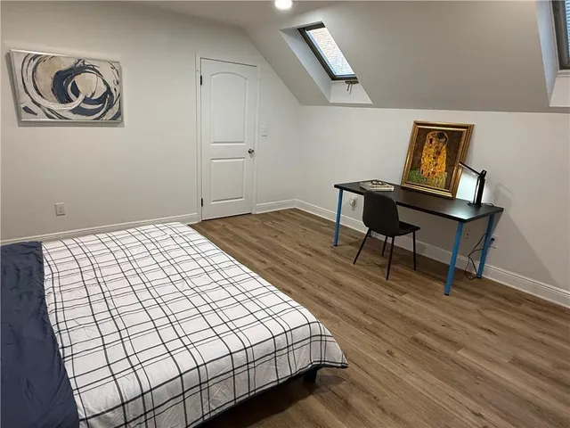 a bedroom with a bed and a table in it