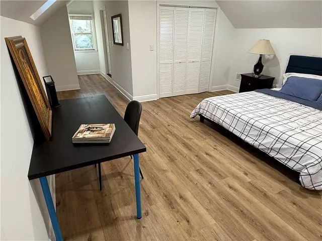 a bedroom with a bed and a table with chair