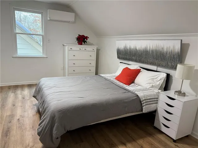 a bedroom with a bed and a dresser