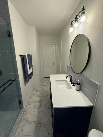 a bathroom with a sink and a mirror