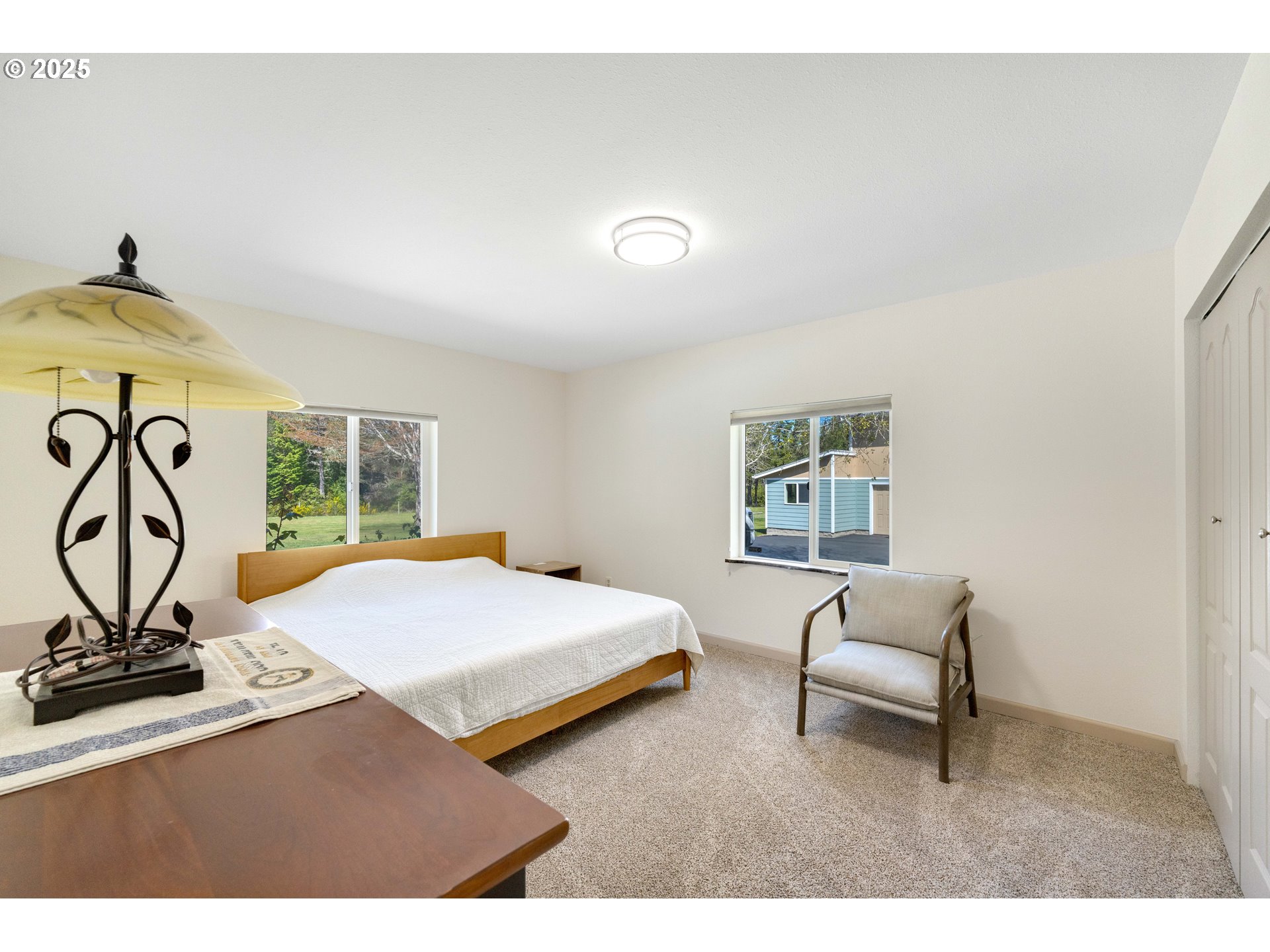 55654 Prosper Jct Road Bandon, OR 97411 - Photo 21 of 48 a living room with a bed furniture and a window