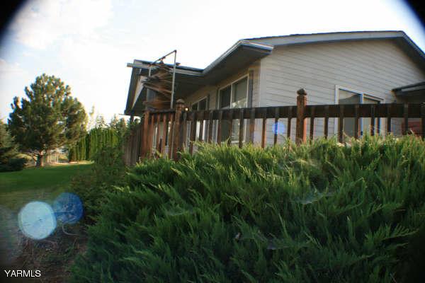 a view of a house with a yard and deck