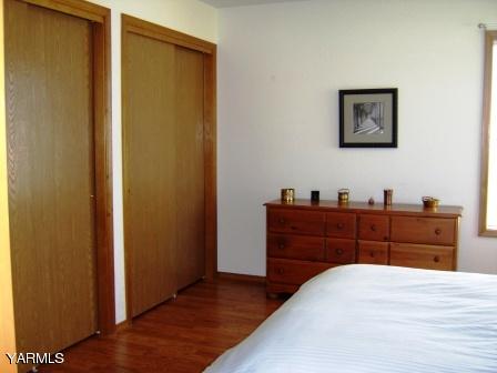910 Thompson Road Cowiche, WA 98923 - Photo 14 of 28 a bed room with a bed and mirror