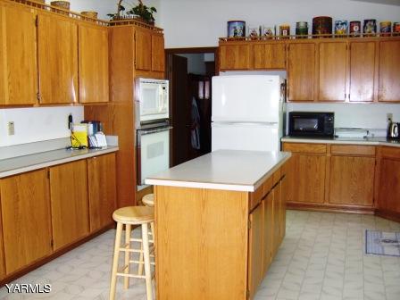 910 Thompson Road Cowiche, WA 98923 - Photo 4 of 28 a kitchen with stainless steel appliances a refrigerator and a stove top oven