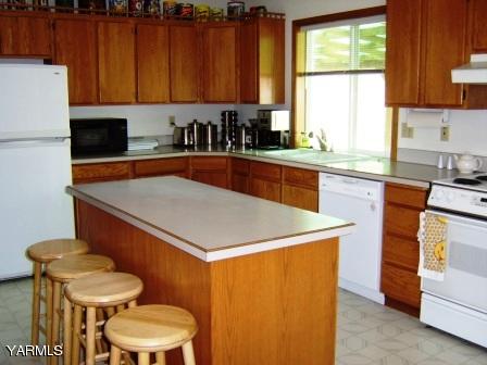 910 Thompson Road Cowiche, WA 98923 - Photo 5 of 28 a kitchen with a sink a stove and a refrigerator
