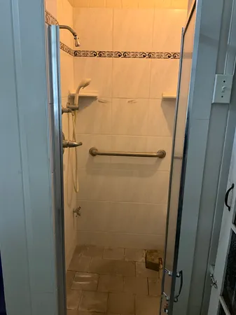 a bathroom with a glass shower door