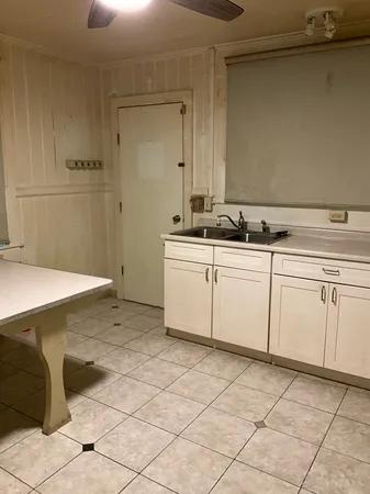 a kitchen with a sink and cabinets
