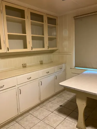 a kitchen with a sink cabinets and wooden floor