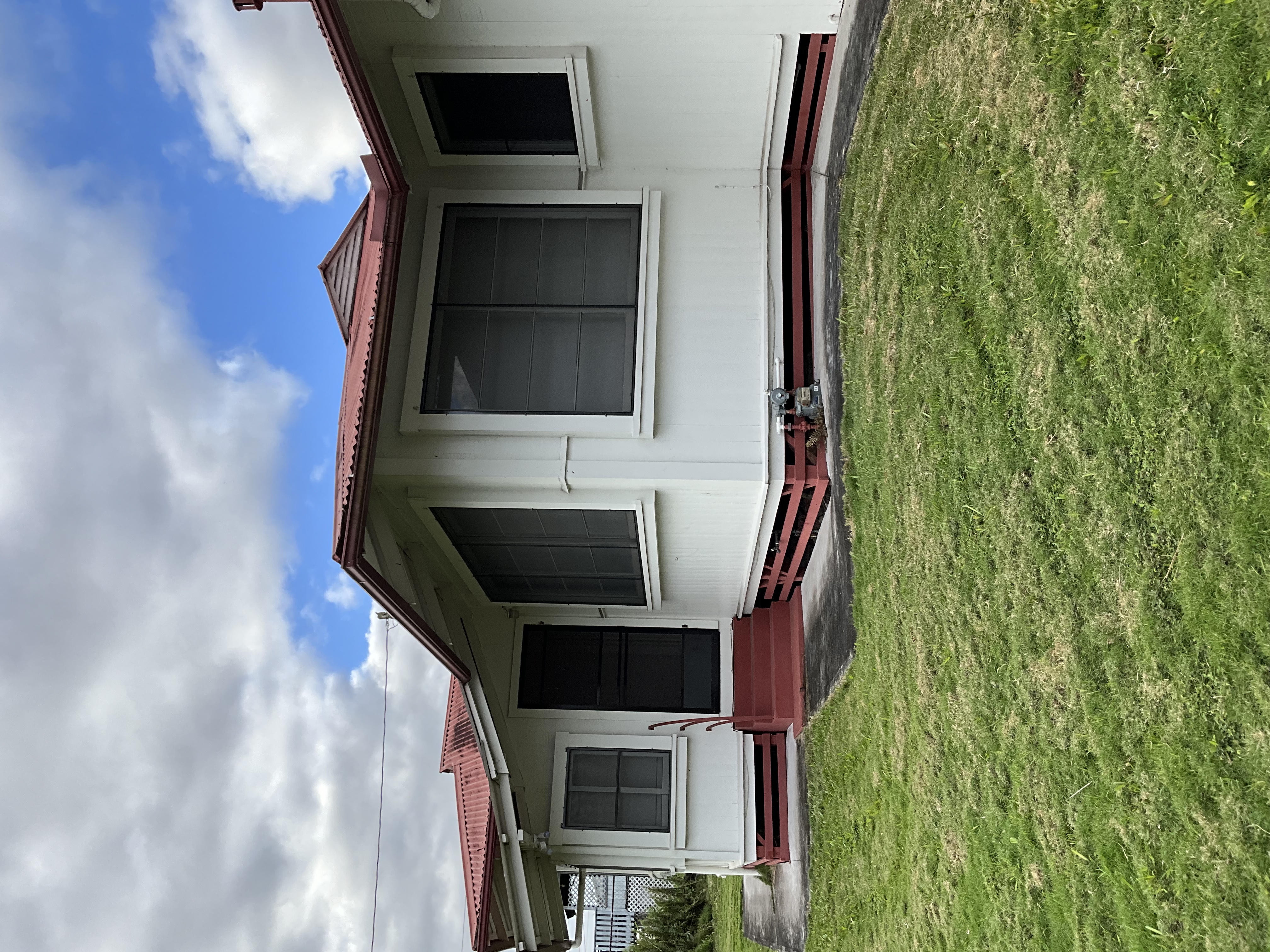 568 Kalanikoa Street, Unit 2 Hilo, HI 96720 - Photo 2 of 24 a front view of a house with a yard and garage