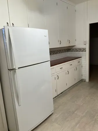 a white refrigerator freezer sitting in a kitchen