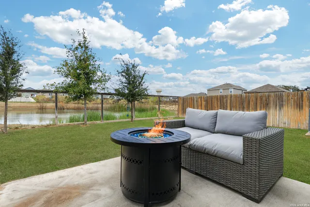 a view of a patio with couches chairs and a big yard