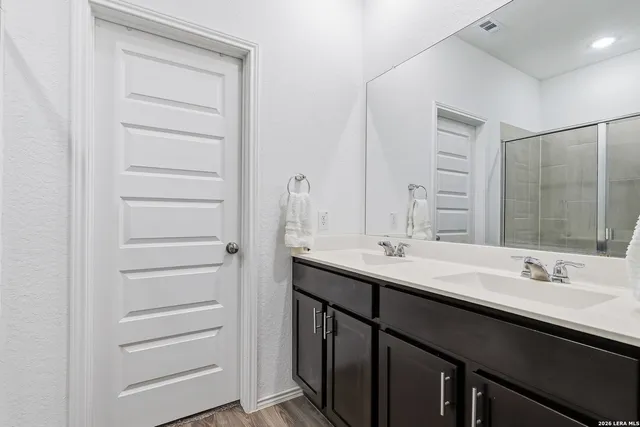 a bathroom with a double vanity sink a and a mirror