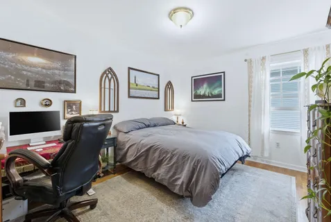 a bedroom with a bed and a couch